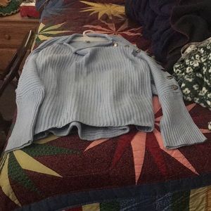 A blue button-sleeve sweater.